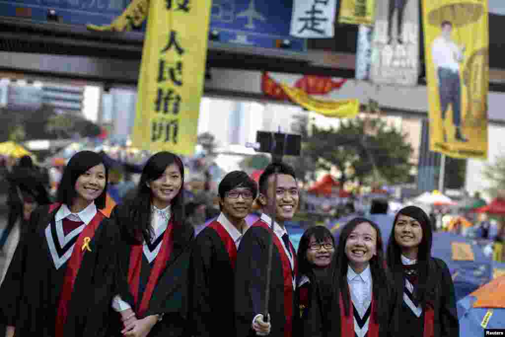 Graduate students have their picture taken at an Occupy Central protest site outside the government headquarters at Admiralty in Hong Kong, Dec. 9, 2014.