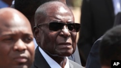 FILE - Zimbabwean President Robert Mugabe attends a funeral in Harare, Zimbabwe, April 12, 2017.