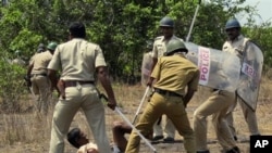 Indian police officers use batons on a villager opposing a government plan to build a nuclear power plant in Jaitapur, Maharashtra state, India, April 19, 2011