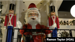 A 15-foot tall, 800-pound robotic Santa Claus, along with wooden toy soldiers, adorn the Polizzottos' home in Dyker Heights, New York.