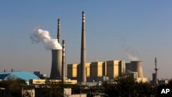 FILE - Smoke billows from a coal-fired power plant in Beijing, China, Nov. 13, 2014.