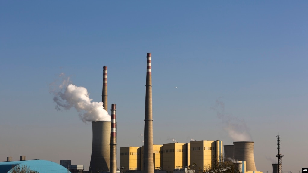 FILE - Smoke billows from a coal-fired power plant in Beijing, China, Nov. 13, 2014.