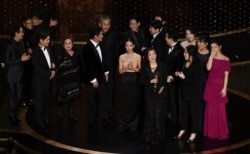 The cast and crew of "Parasite" accept the award for best picture at the Oscars on Sunday, Feb. 9, 2020, at the Dolby Theatre in Los Angeles. (AP Photo/Chris Pizzello)