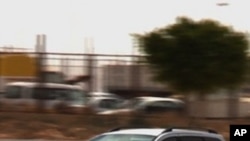 A vehicle sporting an Egyptian diplomatic number plate, is seen driving away from the Sallum border crossing with Libya into Egypt on May 21, 2011.