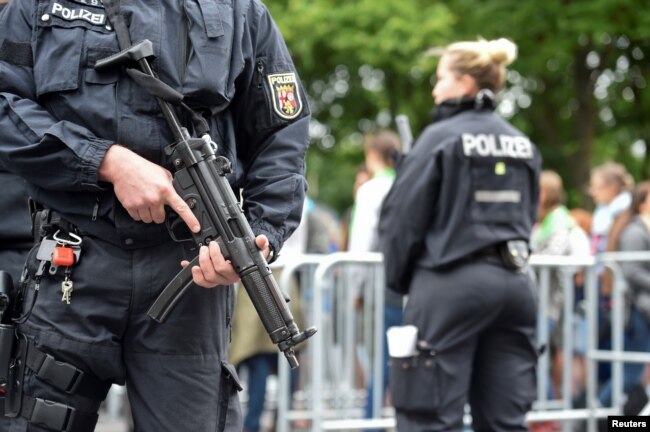 FILE - Police patrol near the Brandenburg Gate in Berlin, Germany, May 24, 2017.