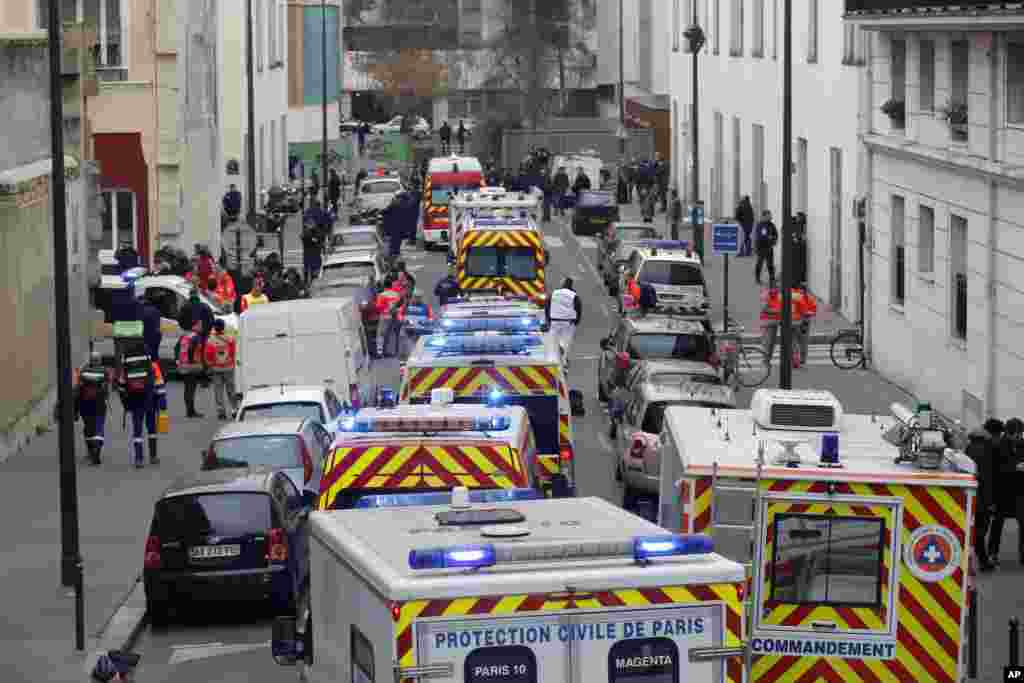 Ambulances rush to the offices of Charlie Hebdo, after a deadly terrorist attack, in Paris, Jan. 7, 2015.