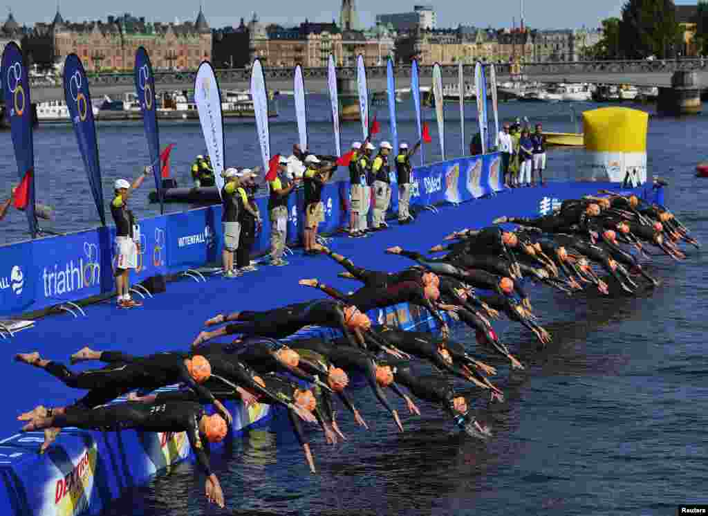 Competitors start the swimming course during the ITU World Triathlon elite race for women in Stockholm, Sweden.