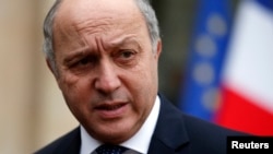 French Minister of Foreign Affairs Laurent Fabius leaves after the weekly cabinet meeting at the Elysee Palace in Paris, Feb. 19, 2014.