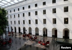 People are pictured in the headquarters of the World Trade Organization in Geneva, Switzerland, April 12, 2017.