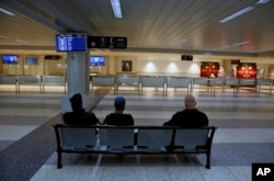 FILE - People wait at the almost empty arrival hall of the Rafik Hariri International Airport during a strike in Beirut, Lebanon, Jan. 4, 2019. Parts of Lebanon's public and private sectors have gone into a strike called for by the country's labor unions to protest worsening economic conditions.