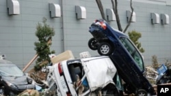 This March 14, 2011 photo shows cars upended and destroyed by the tsunami that struck Sendai port in Miyagi Prefecture, Japan, on March 11.