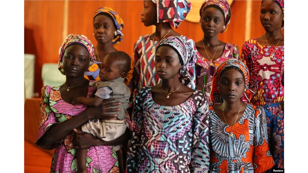 FILE - One of the 21 Chibok schoolgirls released by Boko Haram carries her baby during their visit to meet President Muhammadu Buhari In Abuja, Nigeria, Oct. 19, 2016.