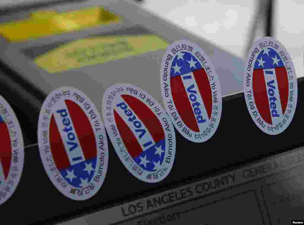 Stickers stating "I Voted" in several languages are affixed to a ballot machine in Los Angeles, California.
