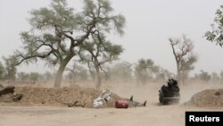 FILE - Cameroonian soldiers from the Rapid Intervention Brigade ride in a military pickup truck at their base in Achigachia, Cameroon, March 16, 2016. 