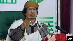 Image taken from Libyan state television broadcast shows Libyan leader Moammar Gadhafi addressing supporters and foreign media in Tripoli, March 2, 2011