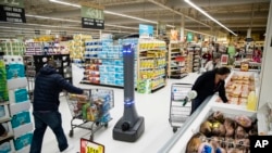 In this Jan. 15, 2019, file photo a robot named Marty cleans the floors at a Giant grocery store in Harrisburg, Pa. (AP Photo/Matt Rourke, File)