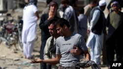 An Afghan man cries as he search for his relatives near Camp Integrity, a base housing US special forces that was attacked by militants, in Kabul, Aug. 8, 2015. 