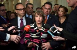 Rep. Michelle Lujan Grisham, D-N.M., chairwoman of the Congressional Hispanic Caucus, center, speaks with reporters on Capitol Hill in Washington, Jan. 17, 2018, following a meeting with the Congressional Hispanic Caucus and White House Chief of Staff John Kelly.