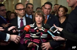 Rep. Michelle Lujan Grisham, D-N.M., chairwoman of the Congressional Hispanic Caucus, center, speaks with reporters on Capitol Hill in Washington, Jan. 17, 2018, following a meeting with the Congressional Hispanic Caucus and White House Chief of Staff John Kelly.