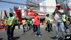 FILE - Union workers protest corruption outside the Public Ministry in Panama City, Feb. 10, 2017. Panama's Attorney General's Office ordered a search of offices belonging to law firm Ramon Fonseca Mora, a partner at Mossack-Fonseca, accusing the firm of setting up offshore accounts that allowed Brazilian construction company Odebrecht to funnel bribes to various countries.