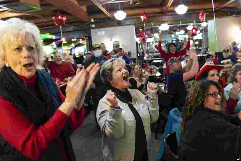 Supporters of President Donald Trump cheer while watching election results at a watch party in Shelby Township, Michigan, Nov. 3, 2020.