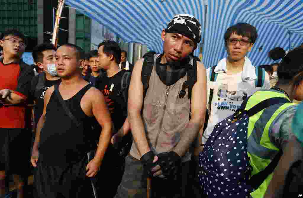 Pro-democracy activists surround and protect their tent as residents and pro-Beijing supporters threaten to tear it down in Mong Kok district, Oct. 3, 2014.