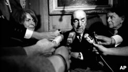 FILE - This Oct. 21, 1971, photo shows Pablo Neruda, poet and then Chilean ambassador to France, talking with reporters in Paris after being named winner of the 1971 Nobel Prize for Literature. 