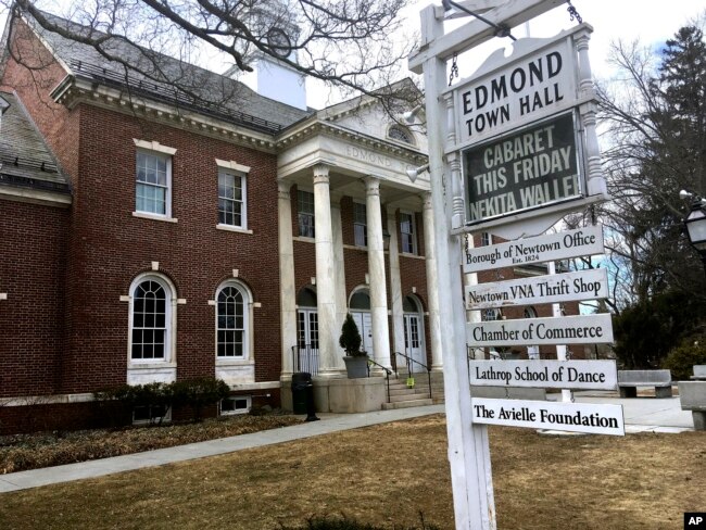 Signs hang outside Edmond Town Hall, a building that houses a community theater and offices, in Newtown, Conn., March 25, 2019. Jeremy Richman, father of Sandy Hook Elementary school shooting victim Avielle Richman, was found dead Monday at the building where he had an office.