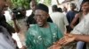 FILE - Opposition presidential candidate Ousainou Darboe greets supporters after casting his vote in Serrekunda, Gambia, Sept. 22, 2006. 