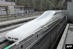 The Central Japan Railway Co.'s seven-car 'magnetic levitation' or maglev train returns to the station after setting a new world speed record in a test run near Mount Fuji, April 21, 2015.