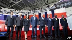Republican presidential candidates (L-R): Rick Santorum, Newt Gingrich, Michele Bachmann, Mitt Romney, Rick Perry, Ron Paul, Herman Cain, and Jon Huntsman stand on stage before the start of the Reagan Centennial GOP presidential primary debate at the Rona
