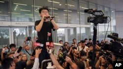 Pro-democracy activist Joshua Wong speaks to protesters near the Legislative Council in Hong Kong, Monday, June 17, 2019. (AP Photo/Kin Cheung)