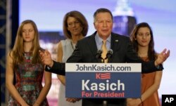 Republican presidential candidate Ohio Gov. John Kasich speaks at his presidential primary election rally in Berea, Ohio, March 15, 2016. His wife, Karen, and twin daughters, Emma, left, and Reese listen.