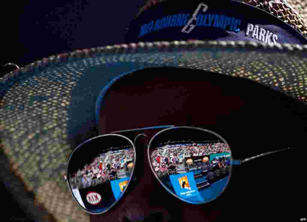 January 21: The crowd at the Hisense Arena is reflected on the sunglasses of a spectator during the match between Maria Sharapova of Russia and Julia Goerges of Germany at the Australian Open tennis tournament in Melbourne. (Reuters/Petar Kujundzic)