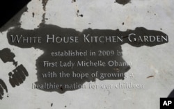 A new paver etched with markings "White House Kitchen Garden" is seen at the entrance to the White House Kitchen Garden at the White House in Washington, Oct. 5, 2016.