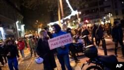 FILE - Protesters hold a sign that reads: "Less Zemmour, more Love", during a demonstration against far right political talk show star Eric Zemmour, in Marseille, southern France, Nov. 26, 2021.