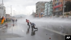FILE - Nepalese police use water cannon to disperse Hindu protestors after they tried to enter a restricted area near the Constituent Assembly hall in Kathmandu, Nepal, Sept 14, 2015. 