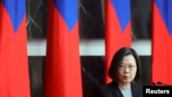 FILE - Taiwan President Tsai Ing-wen speaks at a rank conferral ceremony for military officials from the Army, Navy and Air Force, at the Defense Ministry in Taipei, Dec. 28, 2021.