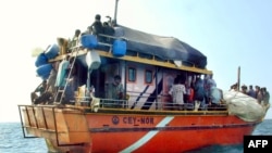 FILE - Sri Lankan asylum seekers stay on their traditional boat near Dili's port.