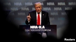 Republican presidential candidate Donald Trump addresses members of the National Rifle Association's during their annual meeting in Louisville, Kentucky.