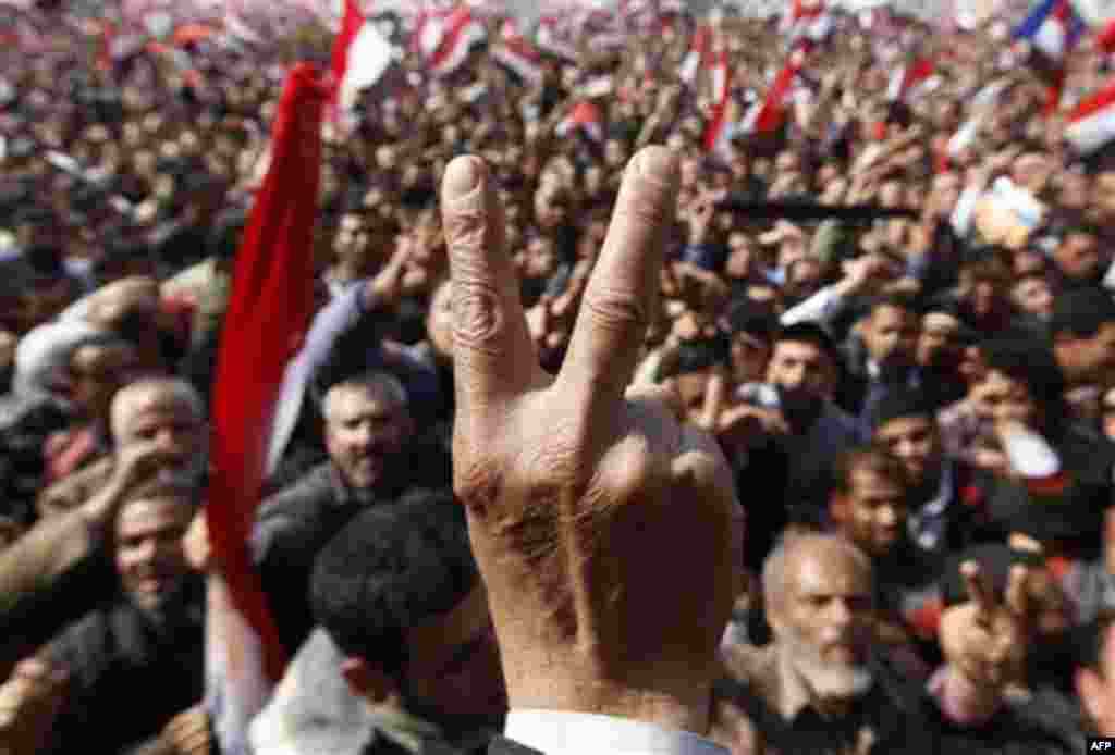 Anti-government protester flashes V sign at Tahrir square, in Cairo, Egypt, Friday, Feb. 11, 2011. Egypt exploded with joy, tears, and relief after pro-democracy protesters brought down President Hosni Mubarak with a momentous march on his palaces and st