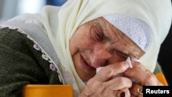 A Bosnian Muslim woman reacts as she awaits the final verdict of former Bosnian Serb military leader Ratko Mladic in the Srebrenica-Potocari Genocide Memorial Center, Bosnia and Herzegovina.