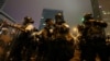 Riot police prepare their gear during a demonstration against a proposed extradition bill in Hong Kong, June 12, 2019. 