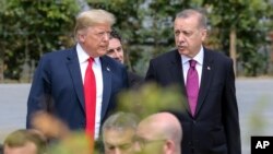 FILE - President Trump, speaks with Turkey's President Recep Tayyip Erdogan ahead of the opening ceremony of the NATO summit in Brussels, July 11, 2018.