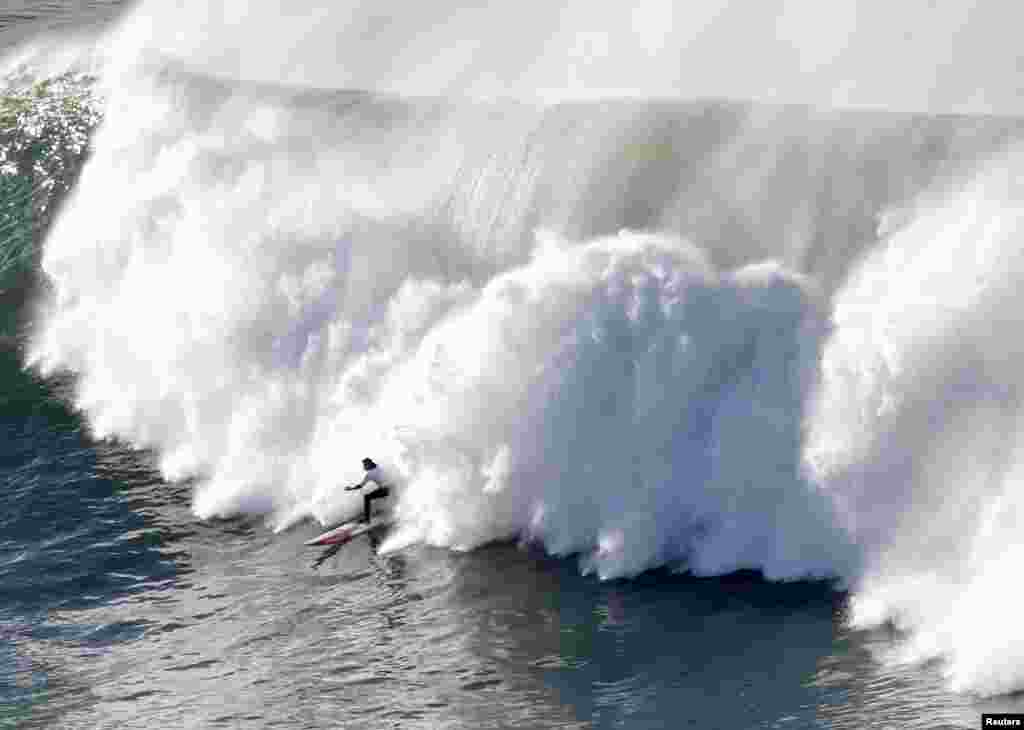 A surfer rides a wave during the Punta Galea Big Wave Challenge in Punta Galea, northern Spain, Dec. 22, 2013.