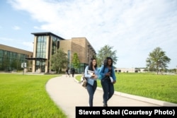 Students walk across campus at Valencia College in Orlando, Florida.