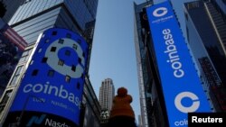 The logo for Coinbase Global Inc, the biggest U.S. cryptocurrency exchange, is displayed on the Nasdaq MarketSite jumbotron and others at Times Square in New York, U.S., April 14, 2021. REUTERS/Shannon Stapleton