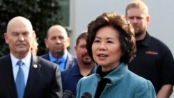 FILE - Transportation Secretary Elaine Chao, right, speaks to reporters outside the West Wing of the White House, March 4, 2019.