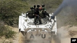 African Union peacekeepers patrol in a tank as they assist Somalia government forces during clashes with insurgents in southern Mogadishu, March 9, 2011