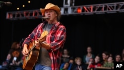 FILE - Neil Young performs at the Bridge School Benefit Concert at the Shoreline Amphitheatre in Mountain View, Calif., Oct. 20, 2012.